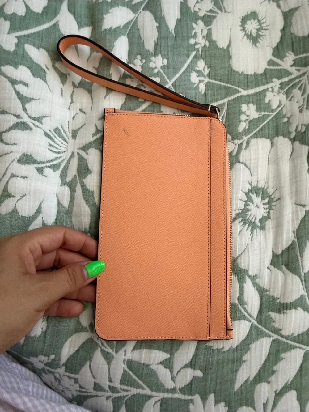 kate spade peach/orange leather wristlet with gold logo